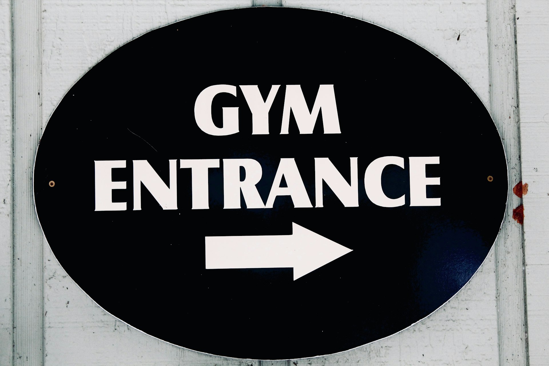 The sign points to the gym entrance.